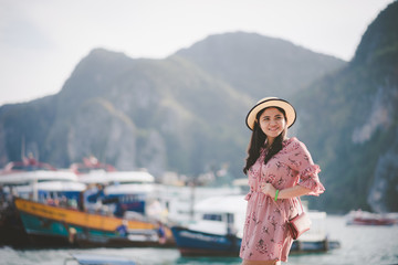 Fototapeta na wymiar Portrait Asian beautiful woman Have fun with the sea. On her holiday on Phi Phi Island, Krabi Province, Thailand