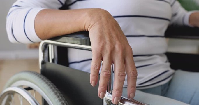 Handicapped disabled old woman sit on wheelchair, close up view