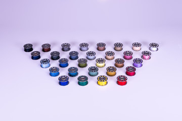 Colorful thread reels on a white background