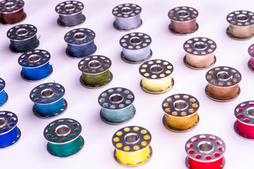 Colorful thread reels on a white background