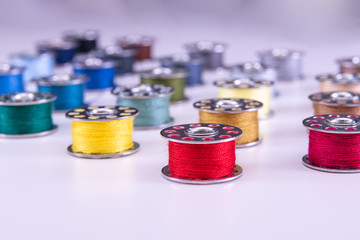 Colorful thread reels on a white background
