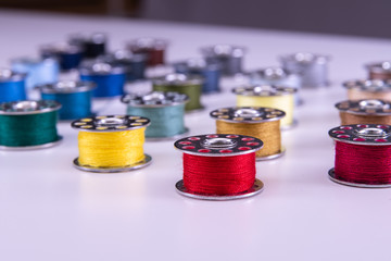 Colorful thread reels on a white background