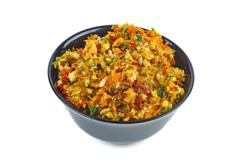 Black ceramic bowl with grinded vegetables isolated on white background