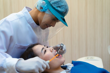 The Doctor is holding the tools for the patient.Dentist examined the patient's teeth at the clinic.Dentists perform dental floss and oral hygiene for patients at the clinic.