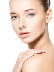 Young woman with healthy clean skin touches the face. Skin care concept.