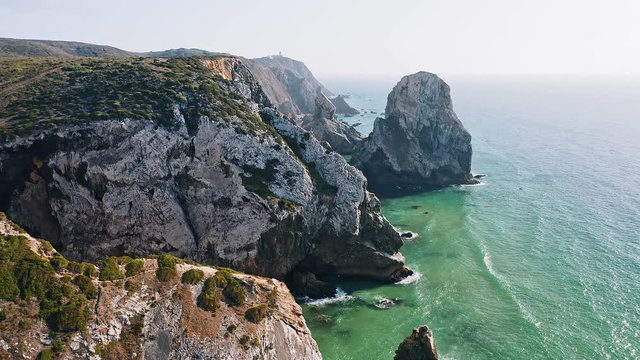 4K Aerial footage of rocky coastline near Praia da Ursa beach and Cabo da Roca located on Atlantic coast in Sintra, Portugal. Europe