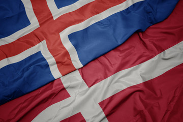 waving colorful flag of denmark and national flag of iceland.