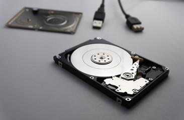 Close up of hard disk's internal mechanism hardware. Soft focus at middle and background.