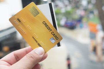 Close up of credit card with paper cinema ticket in hands.