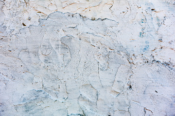 Texture of a concrete wall with cracks and scratches which can be used as a background