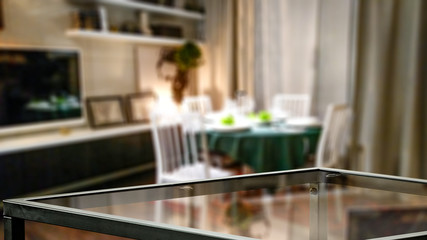 Glass table top with a blurred home interior background. Empty space background for your products and decoration.