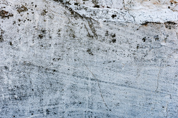 Texture of a concrete wall with cracks and scratches which can be used as a background