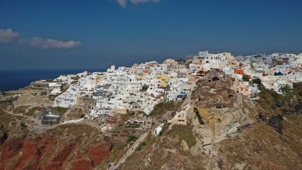 Fototapeta na wymiar Aerial panoramic photo of iconic village of Oia built on a cliff in famous island of Santorini, Cyclades, Greece