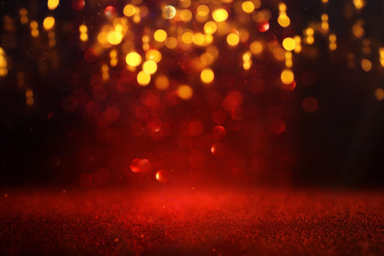 background of abstract red and gold glitter lights. defocused