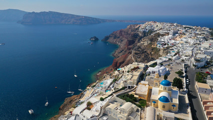 Fototapeta na wymiar Aerial panoramic photo of iconic village of Oia built on a cliff in famous island of Santorini, Cyclades, Greece