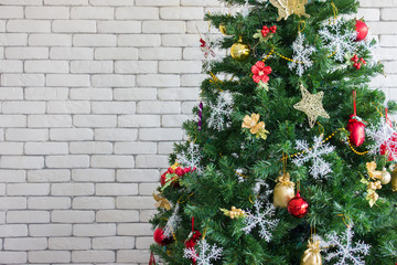 Beautiful decorated Christmas tree with brick wall background