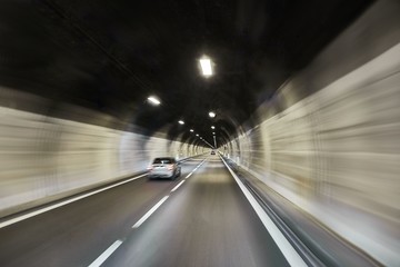 Fototapeta na wymiar Highway tunnel high speed driving motion blur concrpt