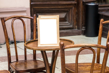 menu in a retro cafe (bar), on a wooden table surrounded by wooden chairs, against the background of an old wooden door, an urn and a stone floor