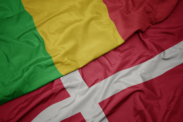 waving colorful flag of denmark and national flag of mali.