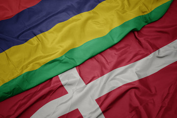 waving colorful flag of denmark and national flag of mauritius.
