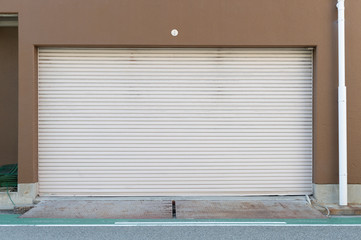 A closeup shot of automatic metal roller door used in factory, storage, garage, and industrial...