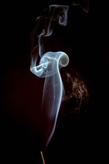 Incense smoke spiral colors on black background