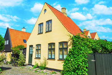 Fototapeta na wymiar Small streets with beautiful, yellow old houses. Traditional Scandinavian houses.Dragor, Denmark. Architecture.