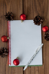 Conceptual composition on a wooden table with notebook with plans for the year. Happy new year background. New goals This year i will and space for your text