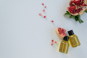 Top view of bottles with pomegranate seed essential oil. Massage cosmetic treatment