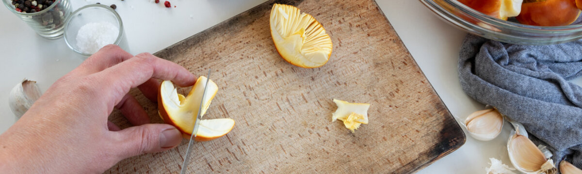 Personal perspective of woman hands preparing Amanita caesarea (known as Caesar's mushroom)