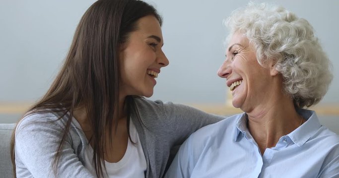 Happy two generation women bonding looking at camera, family portrait