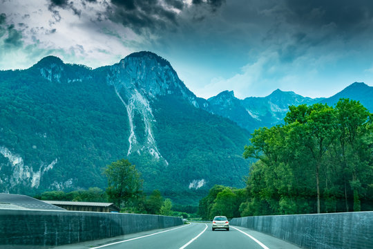Car view on the road and Alps mountains in Switzerland.Photo from inside the car.