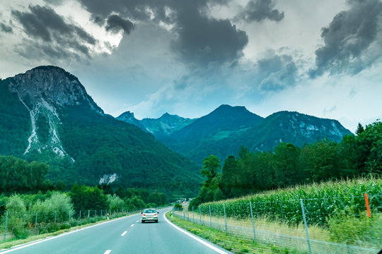 Car view on the road and Alps mountains in Switzerland.Photo from inside the car.