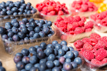 Fresh blackberries and raspberries at a produce stand
