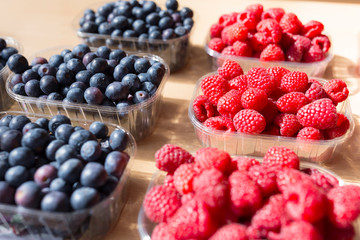Fresh blackberries and raspberries at a produce stand