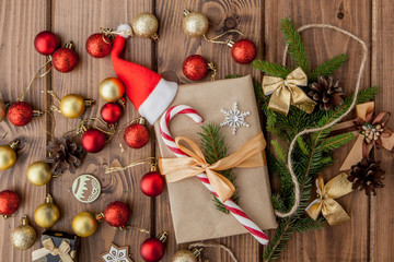 Christmas gift box, food decor and fir tree branch on wooden table. Top view with copy space