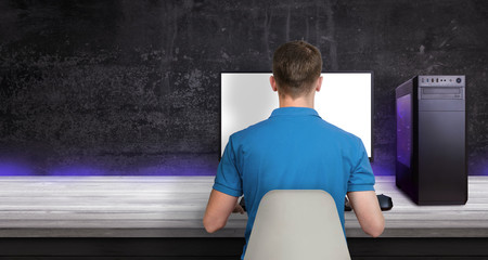 Gamer play game on PC. Modern gaming computer with RGB light. Copy space beside for promo text. © Stanisic Vladimir