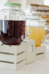 Glass jars of lemonade on wedding candy bar. Catering. Drinks on wedding party