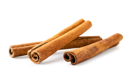 Three cinnamon sticks on a white background, isolated.