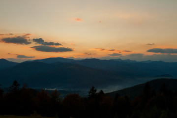 Sunset over the mountains in Ukraine, raising sun beams illuminating an mountainside