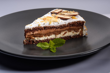 delicious cake with chocolate cream on a black plate3