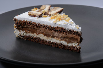 delicious cake with chocolate cream on a black plate1