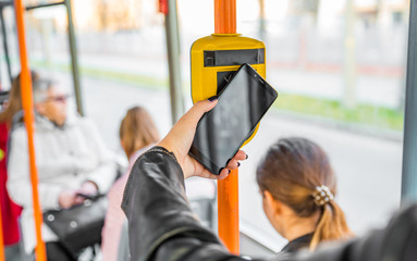 woman hand Paying conctactless with smartphone in public transport