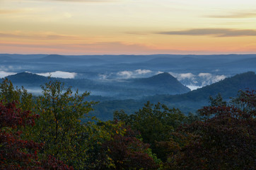 Fototapeta na wymiar View of the fog covered valley below. Taken from the top of Morrow Mountain State Part NC