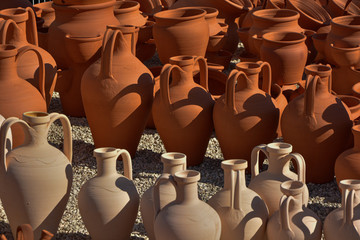 Fototapeta na wymiar ceramic vases set to dry in the sun, contrast of mud tones