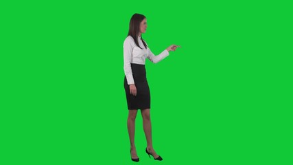 Young business woman or teacher pointing finger showing and talking. Full body isolated on green screen chroma key background