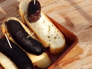 Morzilla/Baldana on a ceramic plate with bread on a wooden table.