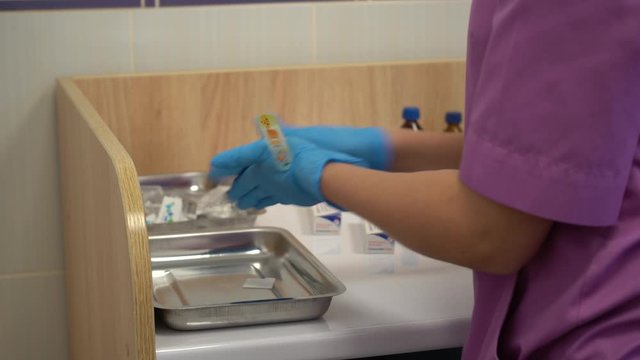 Gloved doctor's hands preparing vaccine for vaccination. Close-up