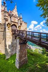 Lichtenstein Castle with wooden bridge, Baden-Wurttemberg, Germany. This fairy tale castle is a landmark of Swabia. Front view of entrance of Lichtenstein Castle in summer. Tourist place in Alps. 