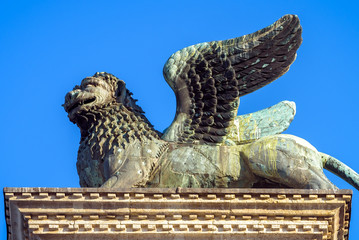 Lion statue at Piazza San Marco (St Mark`s Square), Venice, Italy. Winged lion is an ancient symbol and landmark of Venice. Renaissance architecture and art of Venice close-up.